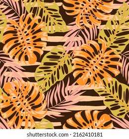 Original seamless tropical pattern with bright plants and leaves on a brown background. Beautiful print with hand drawn exotic plants. Colorful stylish floral. Summer colorful hawaiian.