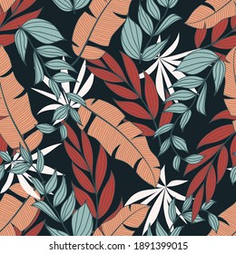 Original tropical seamless pattern with bright exotic plants and leaves on a dark blue background. Colorful stylish floral. Seamless exotic pattern with tropical plants.