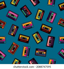 Original vector seamless pattern in vintage style. Old multicolored audio cassettes on a blue background.