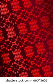 Ornament consisting of refined curls and waves a black silhouette allocated on a red background with a flare in sun rays