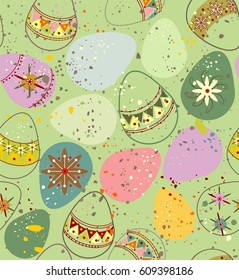 Ornamental Easter eggs in pink, purple, yellow, green, beige and red colors a seamless pattern on a green background.