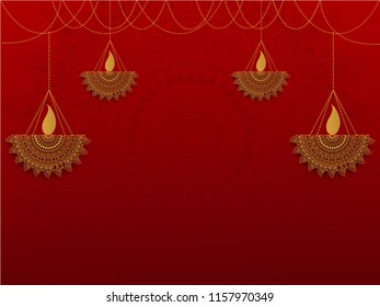 Ornamental floral hanging oil lamps (Diya) on shiny red background with space for your message or text.