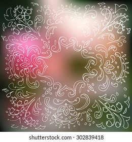 ornamental floral pattern on a blurred background with frame for text,hand drawn 