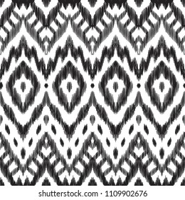 The ornamental ikat pattern on ethnic style. Vector illustration in black and white colors. Exquisite seamless texture can be perfect for background images, wallpapers, textiles, wrapping papers.