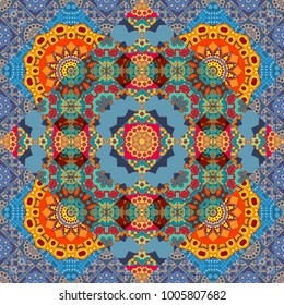 Ornamental motifs of the Indian fabric patterns. Mandalas ethnic seamless pattern in yellow, blue and orange colors. Vector seamless ornament.
