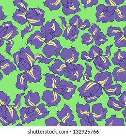 Ornamental seamless pattern of fresh irises on the green background