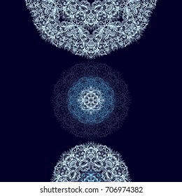 Ornamental vector rosette - snowflake on dark blue background