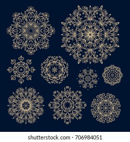 Ornamental vector rosette - snowflake on dark blue background