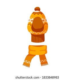 Ornamented childish balaclava and knitted scarf. Winter unisex orange hat with pompon for children. Flat vector cartoon illustration of warm kids headwear isolated on white background