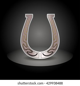 Ornate horseshoe on a black background. Vector illustration