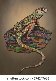 Ornate lizard with ethnic pattern. Rich colored reptile on a beautiful stone. Sunset background