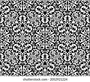 Ornate white pattern on a black background. Demaski seamless elegant pattern. Lace pattern. Black and white color. Vector graphic vintage pattern. For fabric, tile, wallpaper or packaging. 