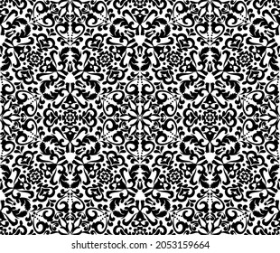 Ornate white pattern on a black background. Demaski seamless elegant pattern. Lace pattern. Black and white color. Vector graphic vintage pattern. For fabric, tile, wallpaper or packaging.