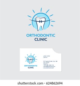 Orthodontist clinic logo. A tooth with braces in blue shine. Business card with a bite of even teeth.