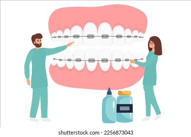 Orthodontist installs dental braces for straightening. Tiny Dentist doctor research X-ray picture of tooth. Dentistry, braces installation, teeth alignment. Prosthetics, Orthodontic treatment,