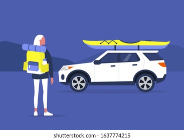 Outdoor active leisure: young female backpacker on a weekend trip, kayaking, hiking