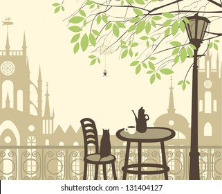 outdoor cafe in the old town with a table and a kettle cat spider