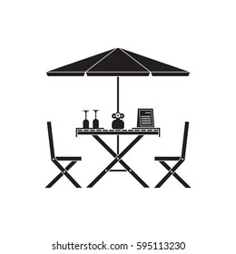 Outdoor romantic table and chairs under parasol with menu, wine bottle and glasses. Summer street cafe terrace silhouette.