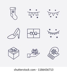 Outline 9 winter icon set. hand with gift box, gift, garland, steep heel, winter glove and winter sock vector illustration