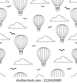 Outline Black and white hot air balloons pattern in cloudy sky with flying birds. Repeatable wallpaper.