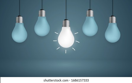 Outstanding gold light bulb on blue background, Think different business concept