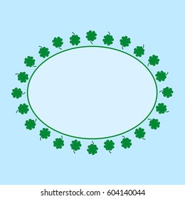 Oval frame with green four-leaf clovers.