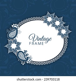 Oval shaped frame with floral design decoration on blue background.