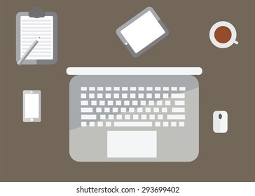 overhead of office table with notebook, coffee and mouse, tablet pc and smartphone