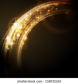 Overlying circle segments with light effects and stars form an abstract golden glowing round border on dark background with a sparkling quality that makes it perfect for the festive Christmas season