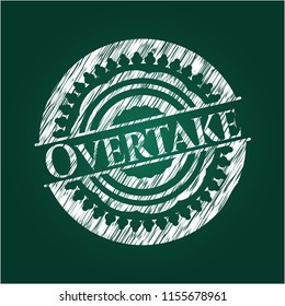 Overtake written on a blackboard