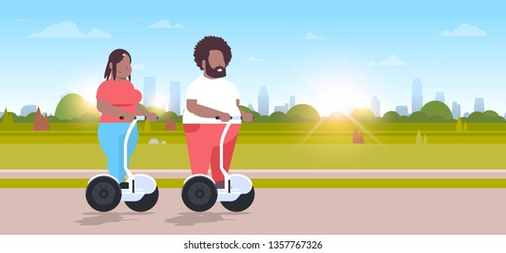 overweight couple riding self balancing scooter city park african american obese man woman on electric gyroscooter weight loss concept full length outdoor landscape background horizontal
