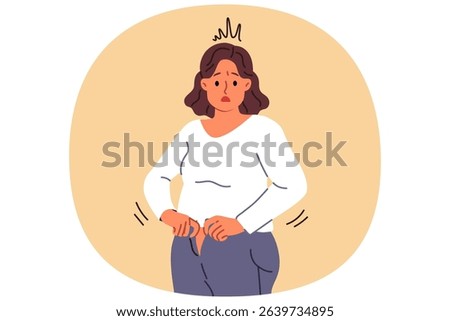 Overweight woman cannot fit into old jeans due to excess weight caused by overeating and sedentary lifestyle. Problem of excess weight surprises girl who needs to follow diet or exercise