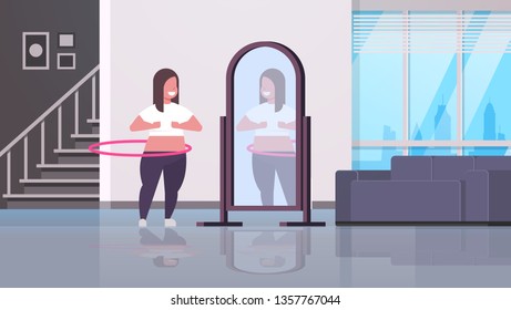 overweight woman doing gymnastic rotating workout with hula hoop looking at reflection in mirror girl weight loss concept modern home apartment interior full length horizontal