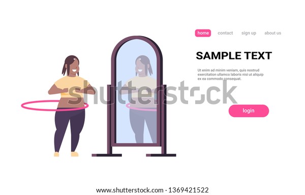 Overweight Woman Doing Gymnastic Rotating Workout With Hula Hoop Looking At Reflection In Mirror African American Girl Weight Loss Concept White Background Copy Space Full Length Horizontal