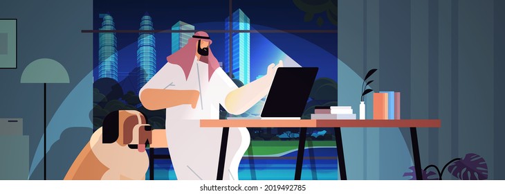 overworked arab businessman freelancer looking at laptop screen man sitting at workplace in dark night home room