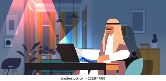 overworked arab businessman freelancer looking at laptop screen arabic man sitting at workplace in dark night home