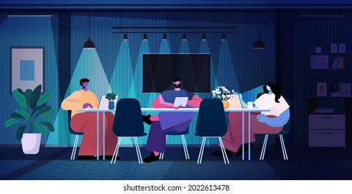 overworked businesspeople discussing during meeting in modern dark night office horizontal full length