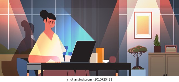 overworked businesswoman freelancer looking at laptop screen woman sitting at workplace in dark night home room