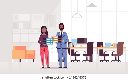 overworked man woman holding folder stack couple african american coworkers standing together paperwork hard working concept modern office interior flat full length horizontal