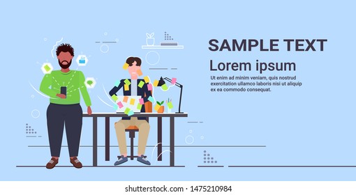 overworked mix race colleagues working together using mobile app covered with sticky notes business planning teamwork concept flat horizontal full length copy space