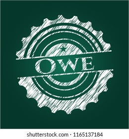 Owe chalkboard emblem written on a blackboard