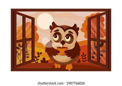 Owl with coffee sits on the window on the background of the autumn landscape 