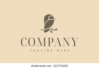 Owl logo design. Bird perched on a tree branch. Mascot design.