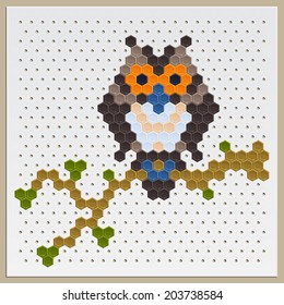 owl on a branch of tiles laid out in different colors on a special board for mosaic