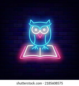 Owl on open book neon sign. Smart education idea. School concept. University emblem. Back to school design. Knowledge label. Glowing advertising on brick wall. Vector stock illustration