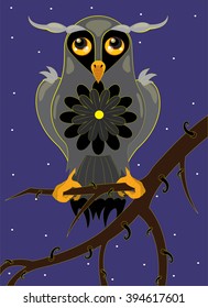 The owl sits on a tree branch at night
