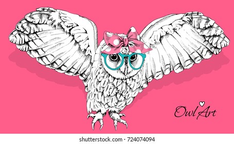 Owl with the spread wings in a green glasses and in a polka dot headband on a pink background. Vector illustration.