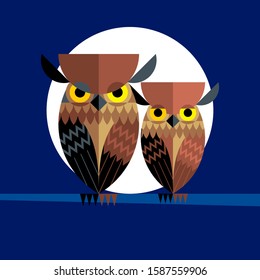 Owls family in the night sitting on a branch