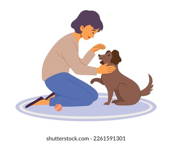Owner plays with dog who gives a paw. The girl on the mat is stroking the puppy.
