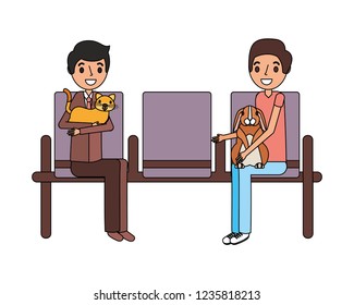 owners with rabbit and cat waiting on chairs